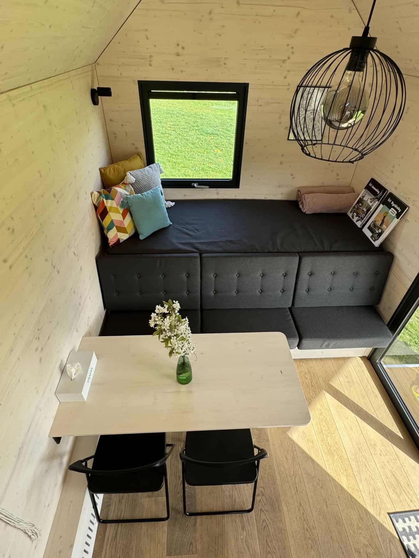 Dining area and sofa in tiny house Hutka — Johanka glamping