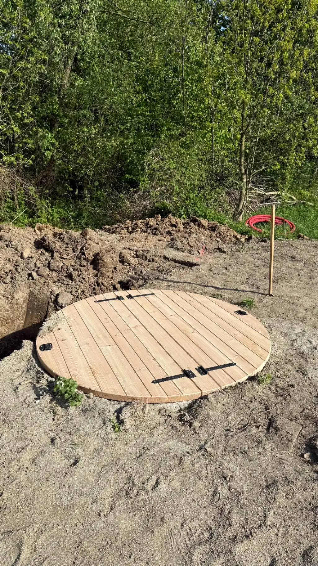 Restored well with larch wood cover and forged hinges